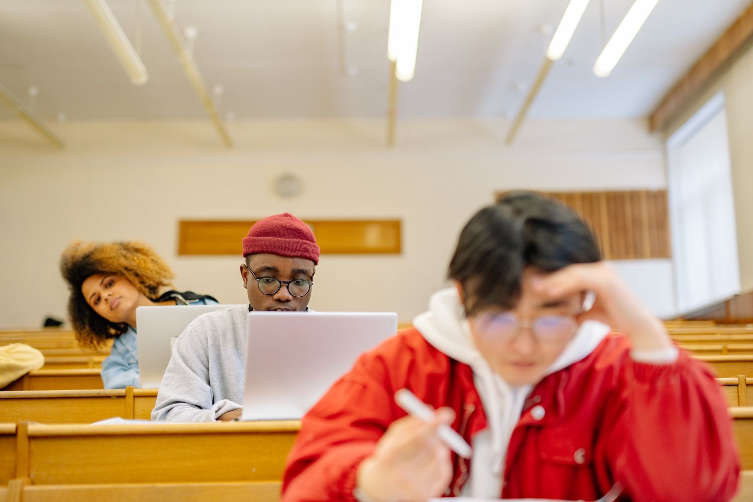 Students working at desks in a university classroom